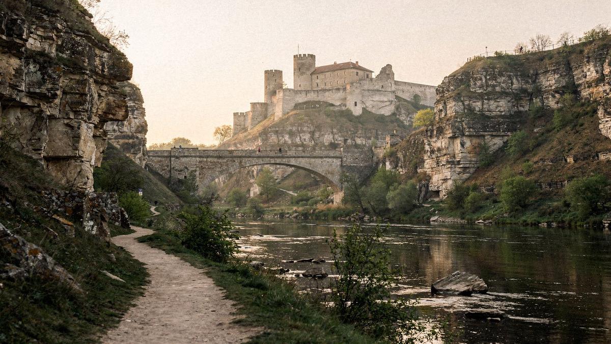 Kamianets-Podilskyi fortress seen from the canyon path in calm morning light